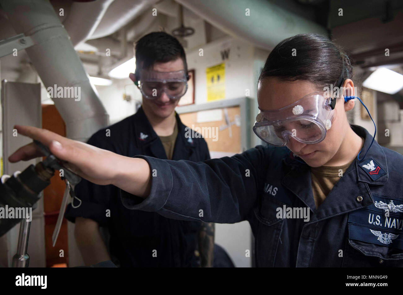MEDITERRANEAN SEA (March 13, 2018) Damage Controlman 2nd Class Julie Sesmas does checks on an air relief valve aboard the Arleigh Burke-class guided-missile destroyer USS Donald Cook (DDG 75) March 13, 2018. Donald Cook, forward-deployed to Rota, Spain, is on its seventh patrol in the U.S. 6th Fleet area of operations in support of regional allies and partners, and U.S. national security interests in Europe and Africa. Stock Photo