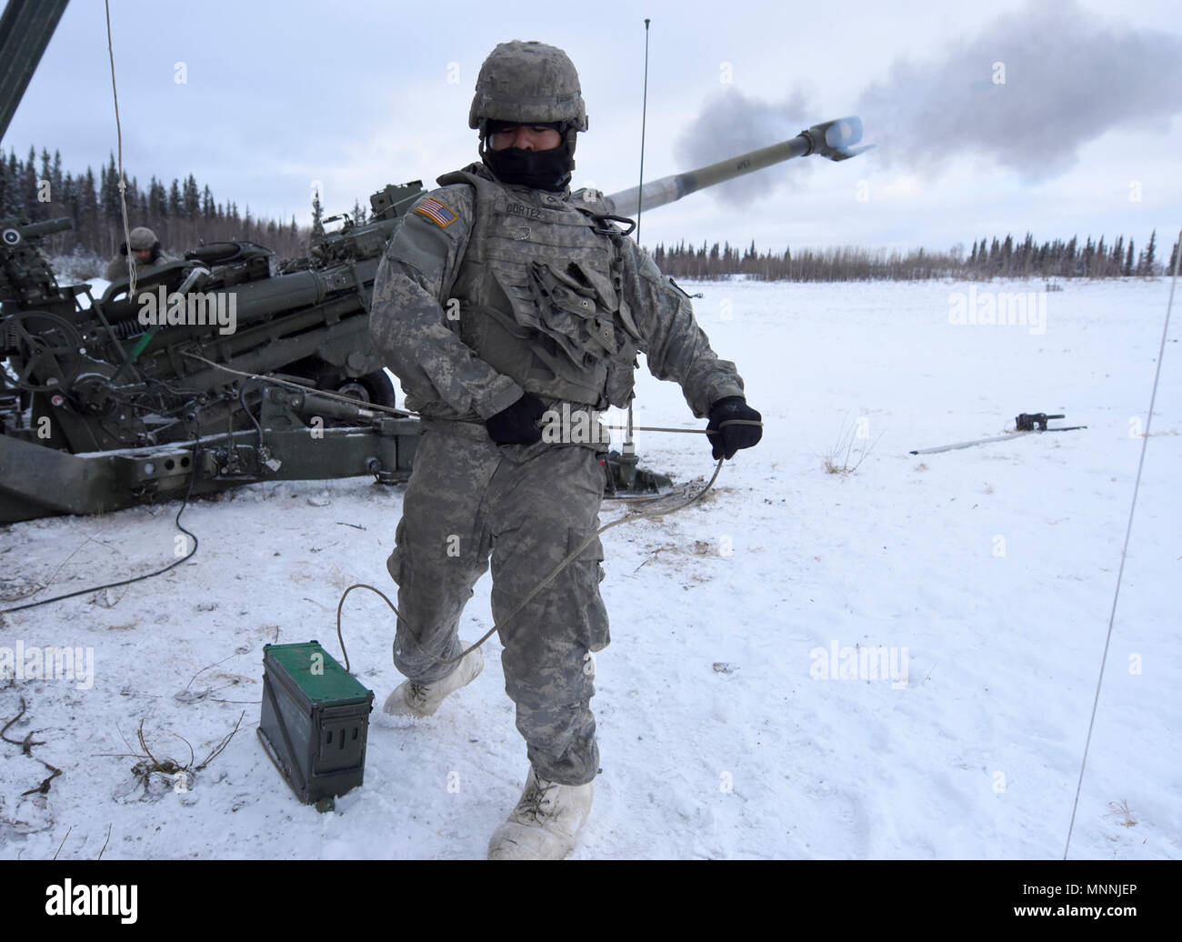 Pfc. Gerson Cortez, a cannon crew member assigned to 1st Stryker Brigade Combat Team, 25th Infantry Division, 2nd Battalion, 8th Field Artillery Regiment fires a M777 155mm Howitzer March 15 during a live fire training exercise at Fort Greely, Alaska, as part of the U.S. Army Alaska-led Joint Force Land Component Command in support of Alaskan Command's exercise Arctic Edge 18 conducted under the authority of U.S. Northern Command. Arctic Edge 2018 is a biennial, large-scale, joint-training exercise that prepares and tests the U.S. military's ability to operate tactically in the extreme cold-we Stock Photo