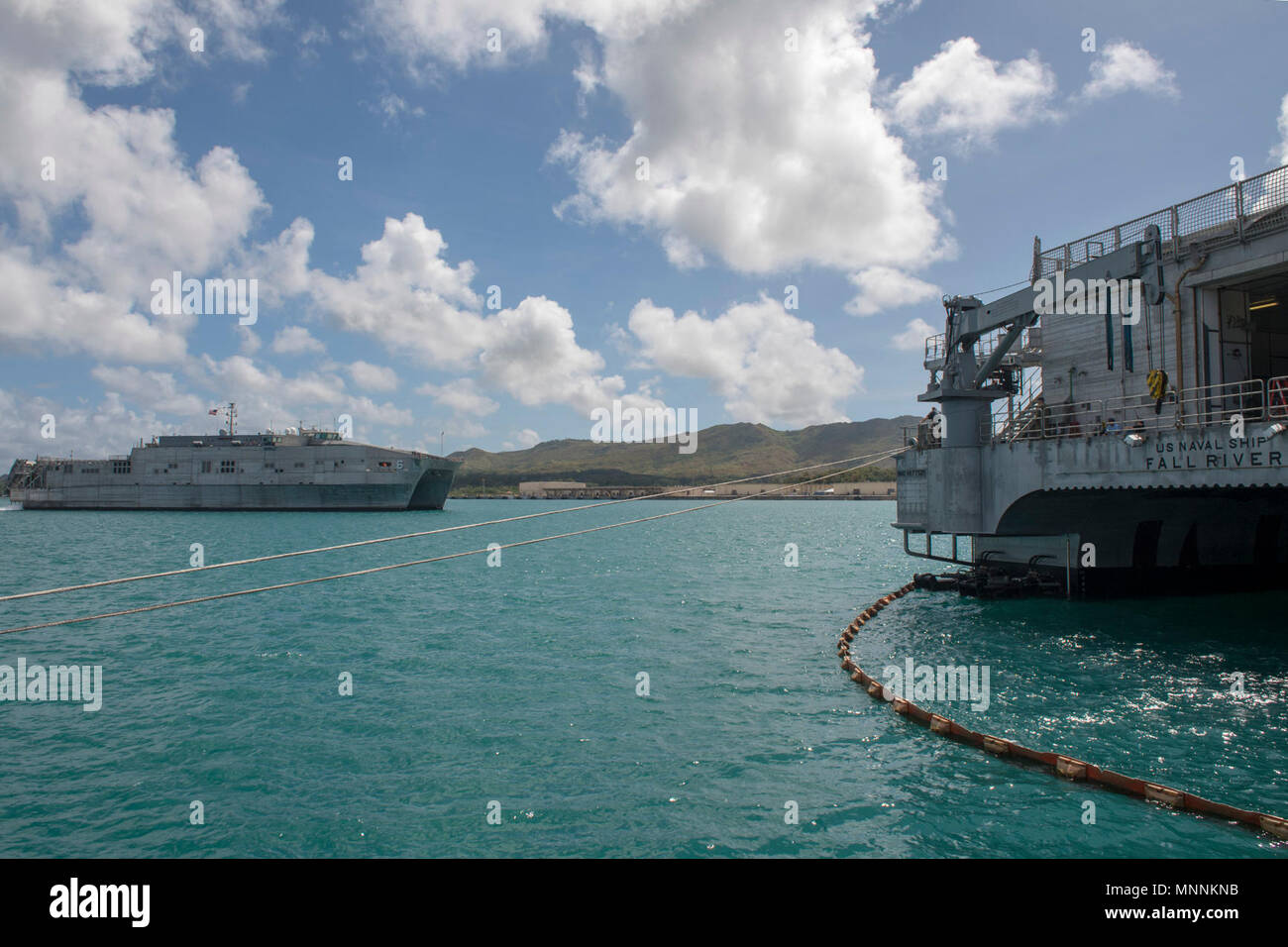 NAVAL BASE GUAM (March 16, 2018) Military Sealift Command expeditionary fast transport ship USNS Brunswick (T-EPF 6) approaches the port side of Military Sealift Command expeditionary fast transport ship USNS Fall River (T-EPF 4) as Brunswick prepares to moor in Guam in support of Pacific Partnership 2018 (PP18). PP18’s mission is to work collectively with host and partner nations to enhance regional interoperability and disaster response capabilities, increase stability and security in the region, and foster new and enduring friendships across the Indo-Pacific Region. Pacific Partnership, now Stock Photo