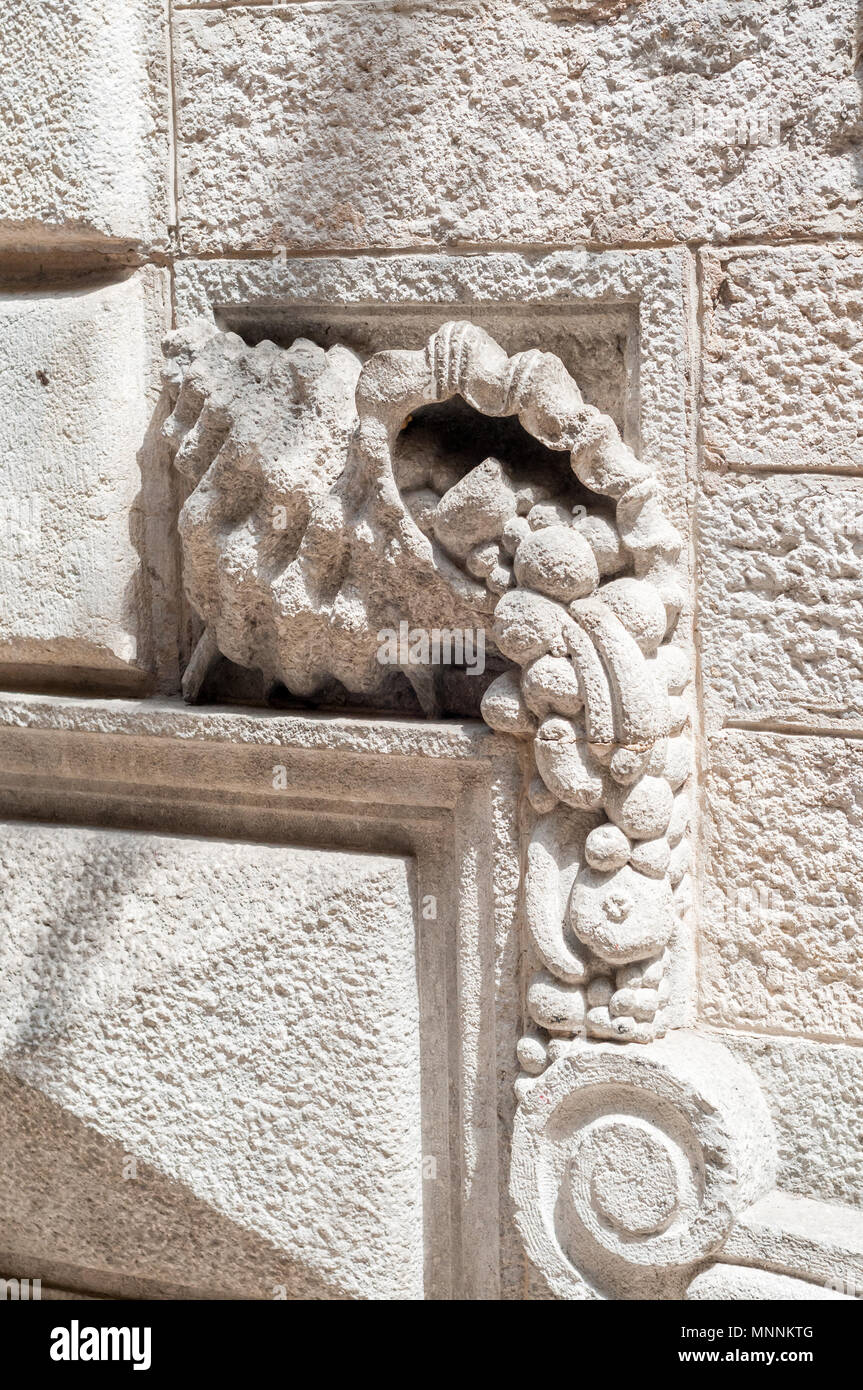 Cornucopia, horn of plenty, large horn-shaped container overflowing with produce, stone sculpture on the wall, Girona, Catalonia, Spain Stock Photo