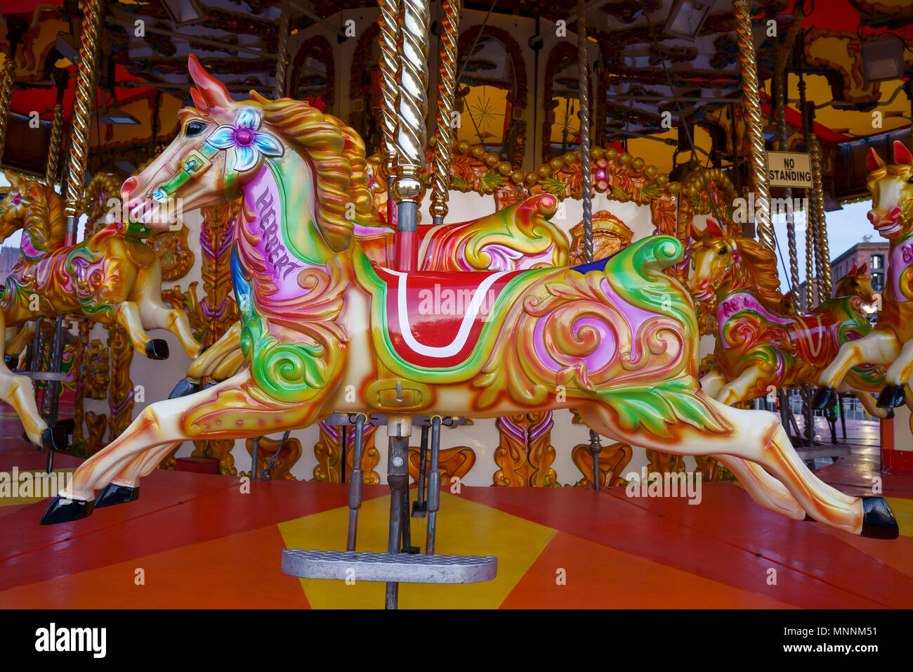 Horses on a fairground carousel ride Stock Photo