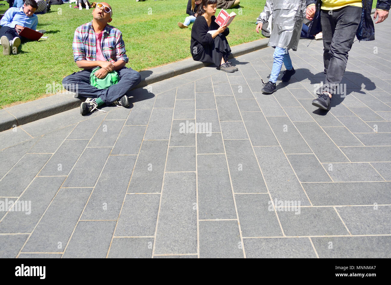 People relaxing in the sun, central London, England, UK. Stock Photo