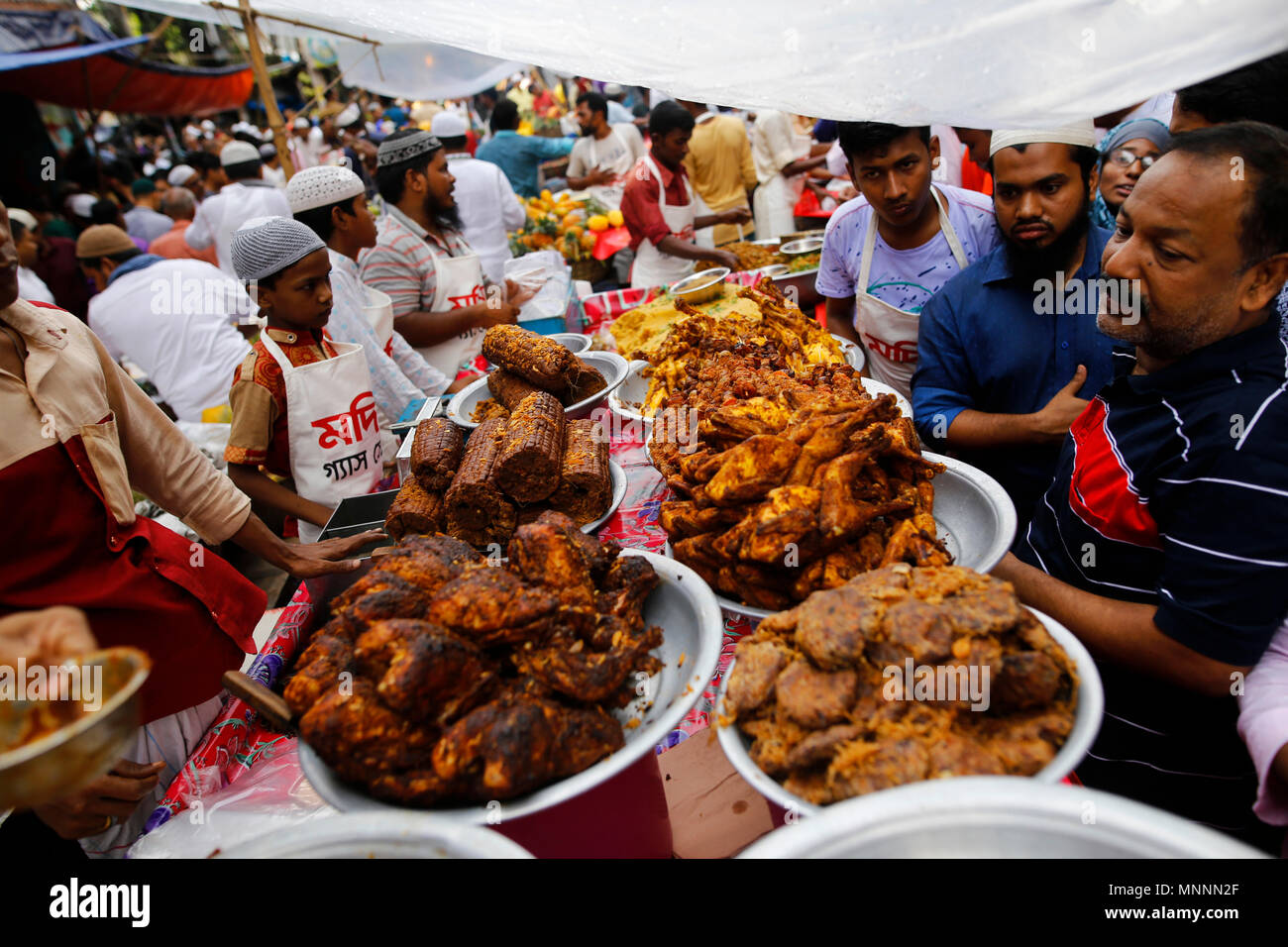 Dhaka, Bangladesh. May 18, 2018. Traditional iftar items on sale at makeshift shop at chawkbazar  in Old part of Dhaka, Bangladesh on May 18, 2018. Dhakaâ€™s residents gathered at the iftar market to buy traditional ifter items, which are Barobaper Polay Khay, giant beef, chicken and mutton roasts, pigeon roast, koel roast, kima roll, kima paratha, borhani, doi bora and different types of kebabs, including Shami, Suti, Jali, Irani, Tika, vegetables, sweets, milk and other ingredients. Â© Rehman Asad / Alamy Stock Photo Stock Photo