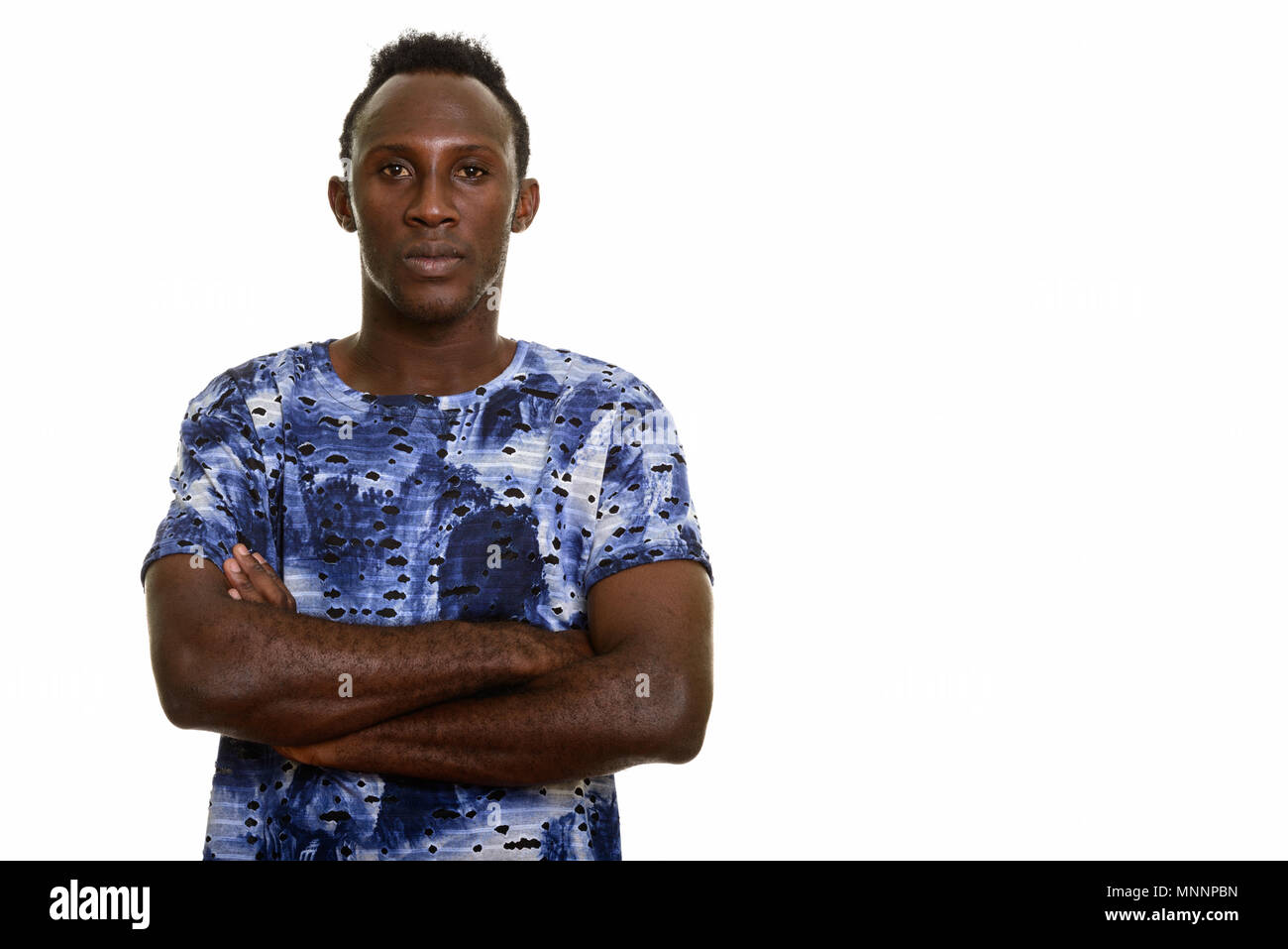 Young black African man with arms crossed Stock Photo - Alamy