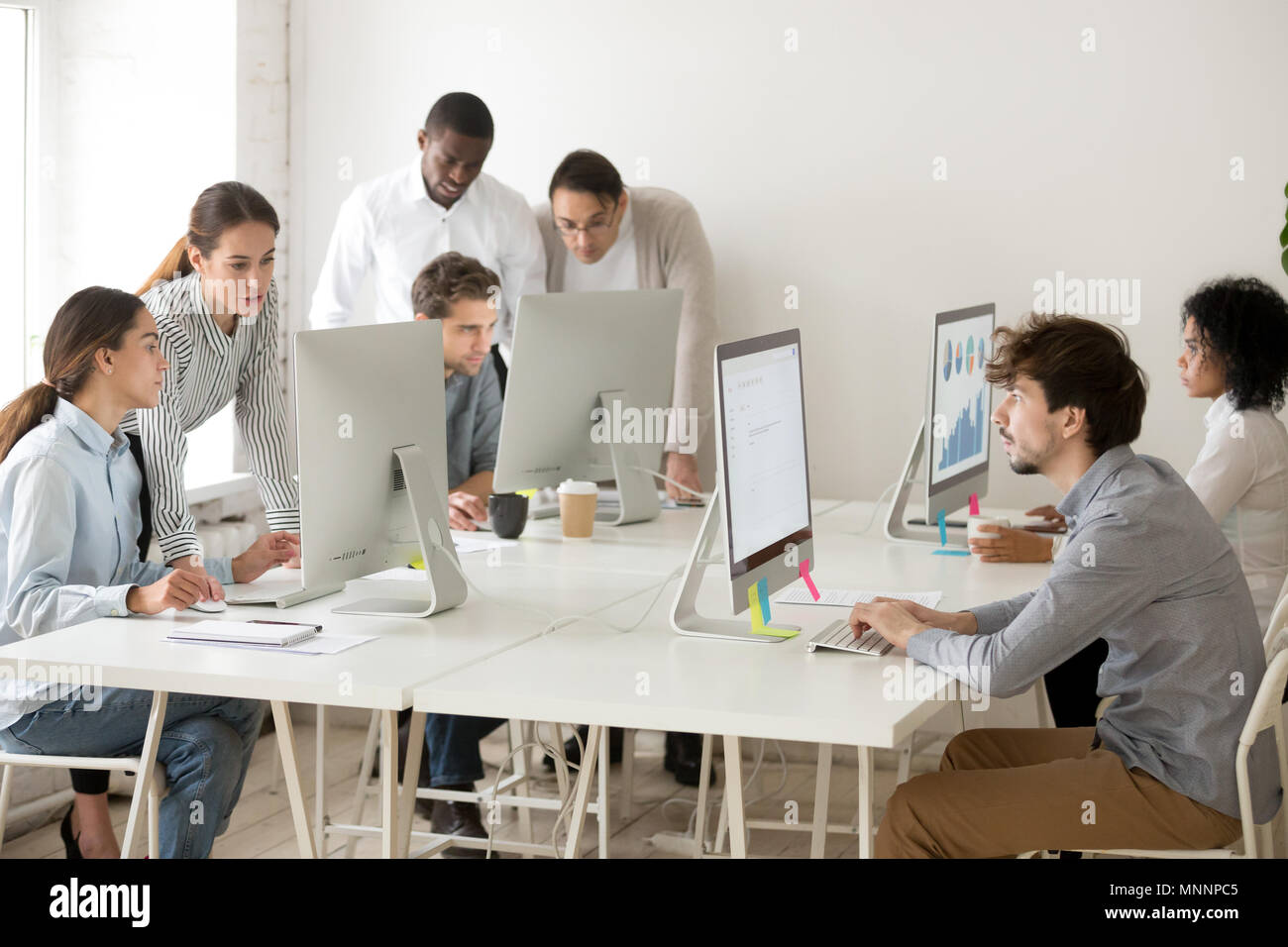 Focused multiracial business people working online on computers  Stock Photo