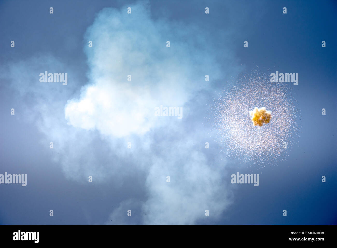 Abstract firework explosion with blue sky at the background. Stock Photo