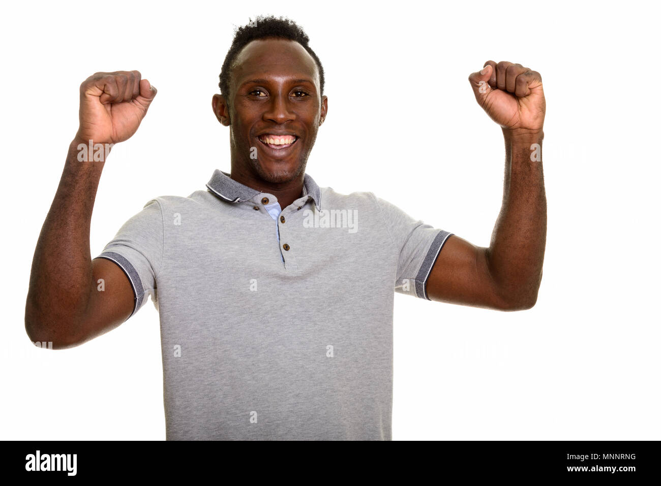 Young happy black African man smiling and looking excited Stock Photo