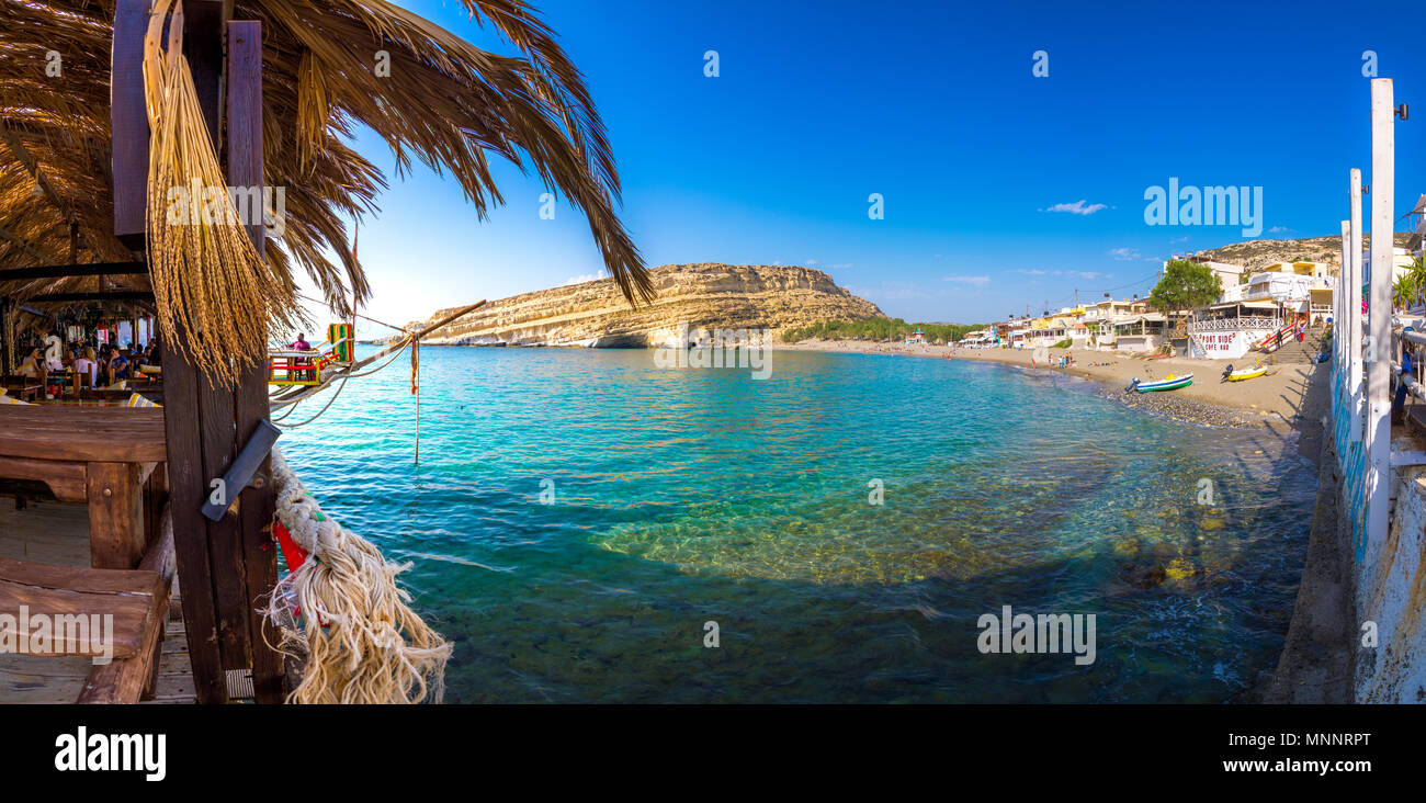 Matala with caves on the rocks that were used as a roman cemetery and at the decade of 70's were living hippies from all over the world, Crete, Greece Stock Photo
