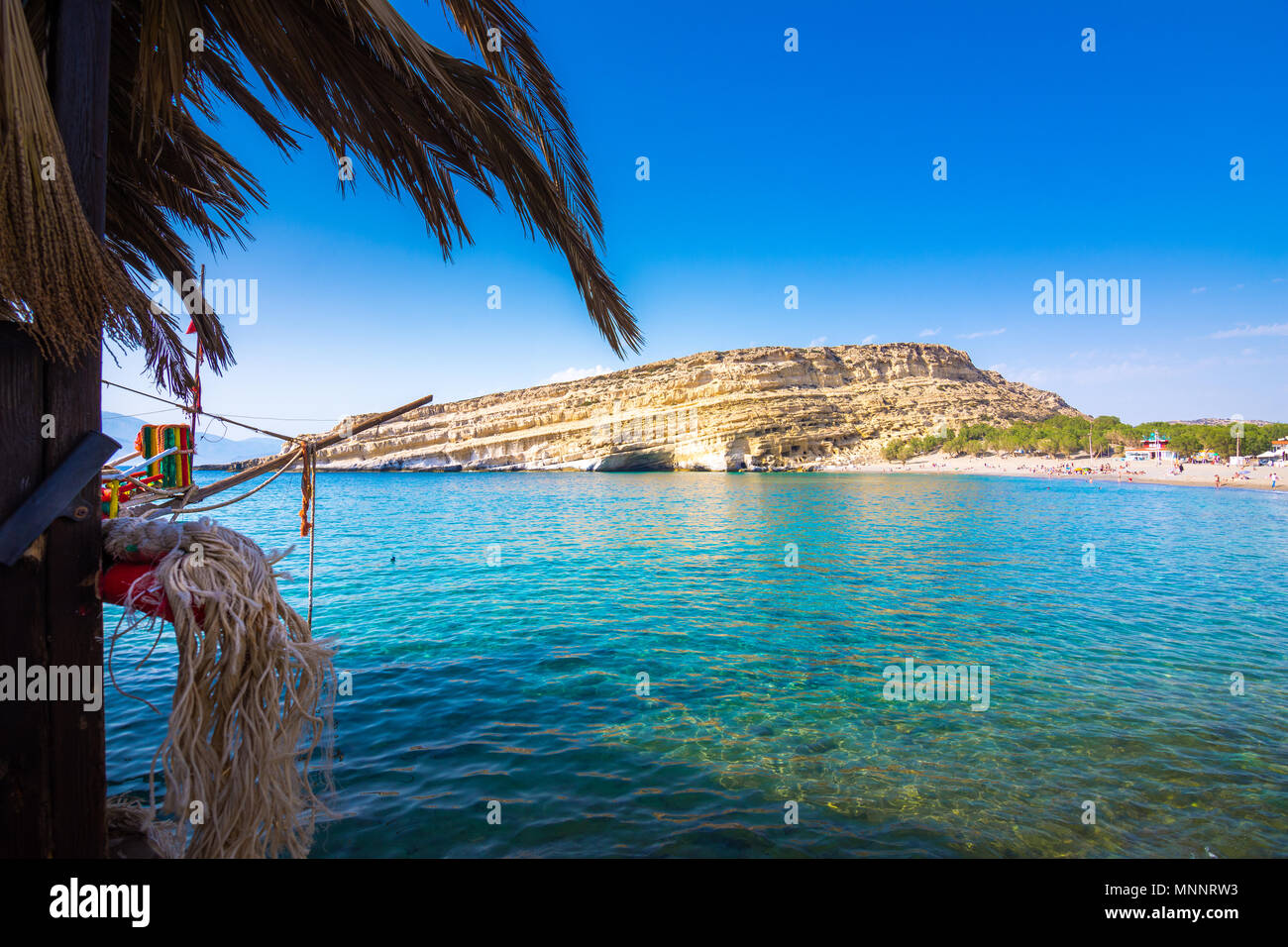 Matala with caves on the rocks that were used as a roman cemetery and at the decade of 70's were living hippies from all over the world, Crete, Greece Stock Photo