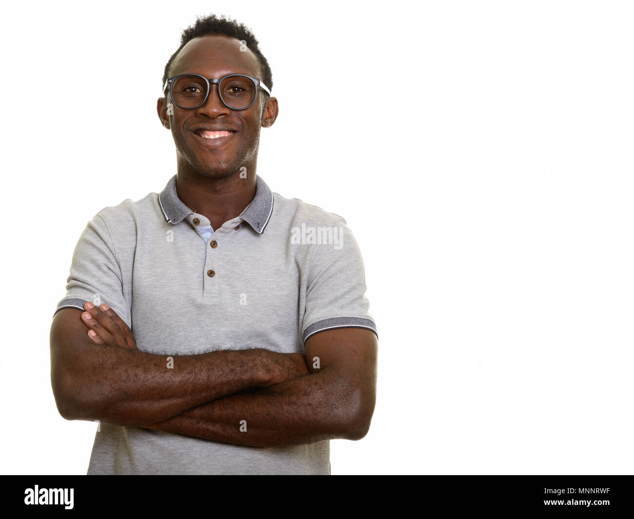 Young happy black African man smiling with arms crossed Stock Photo - Alamy