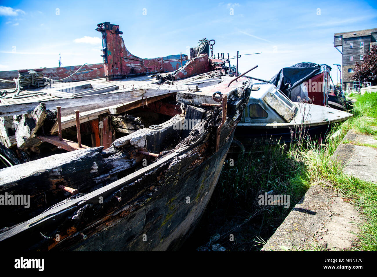 Rotting Wooden Structure of an old cargo  barge on the canal bank Stock Photo