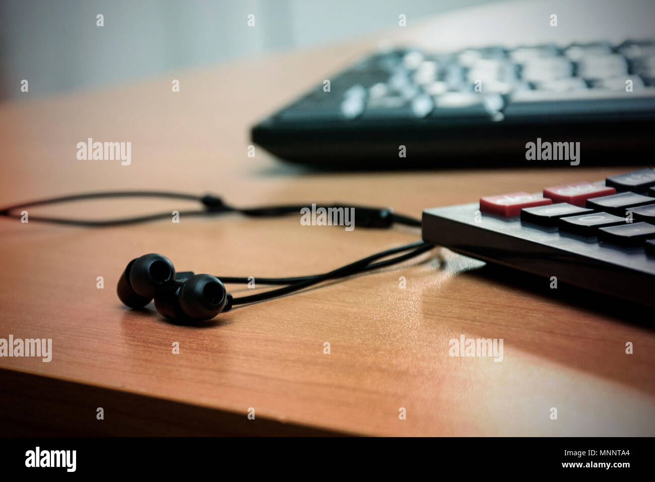 Desk with keyboard, calculator and headphones Stock Photo Alamy