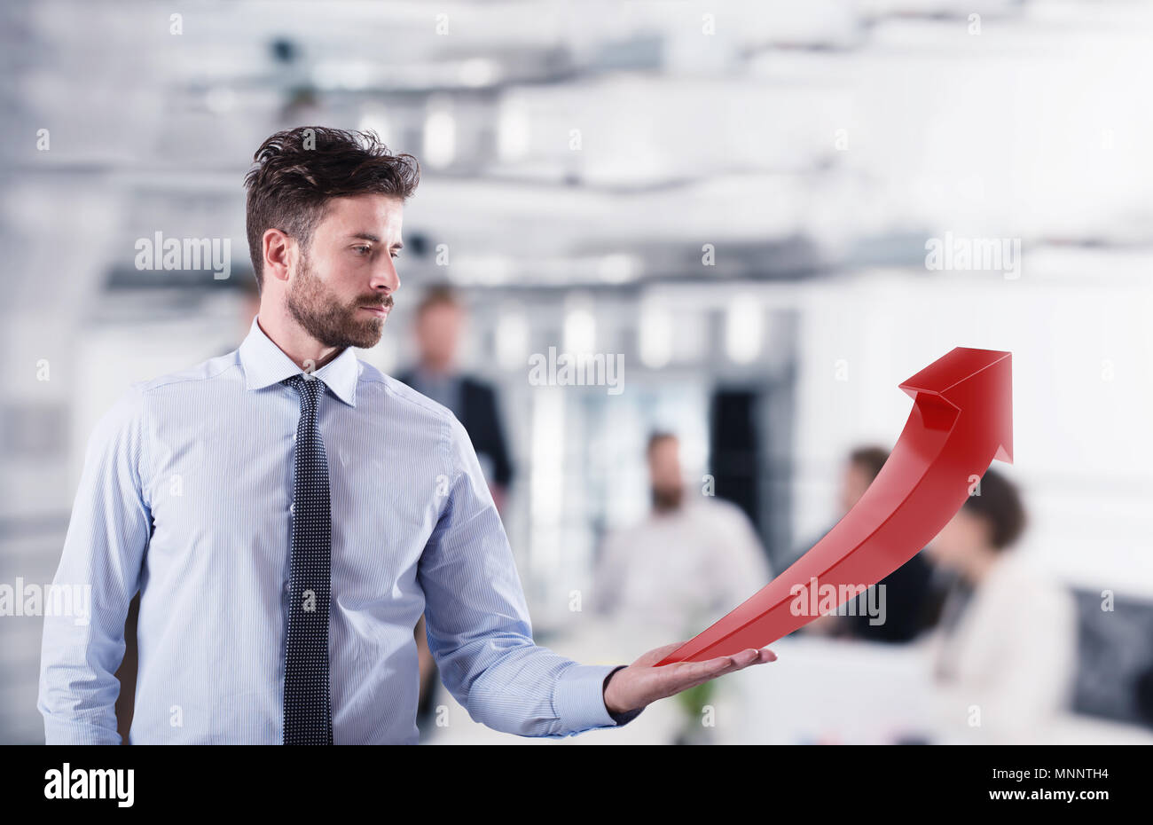 Businessman holds a growing statistic company Stock Photo