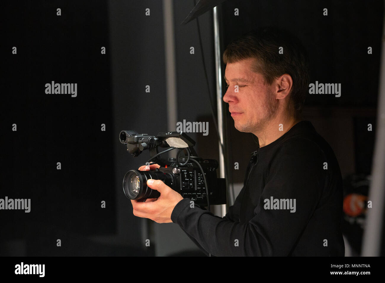 camera operator working with a cinema camera on the work site Stock ...