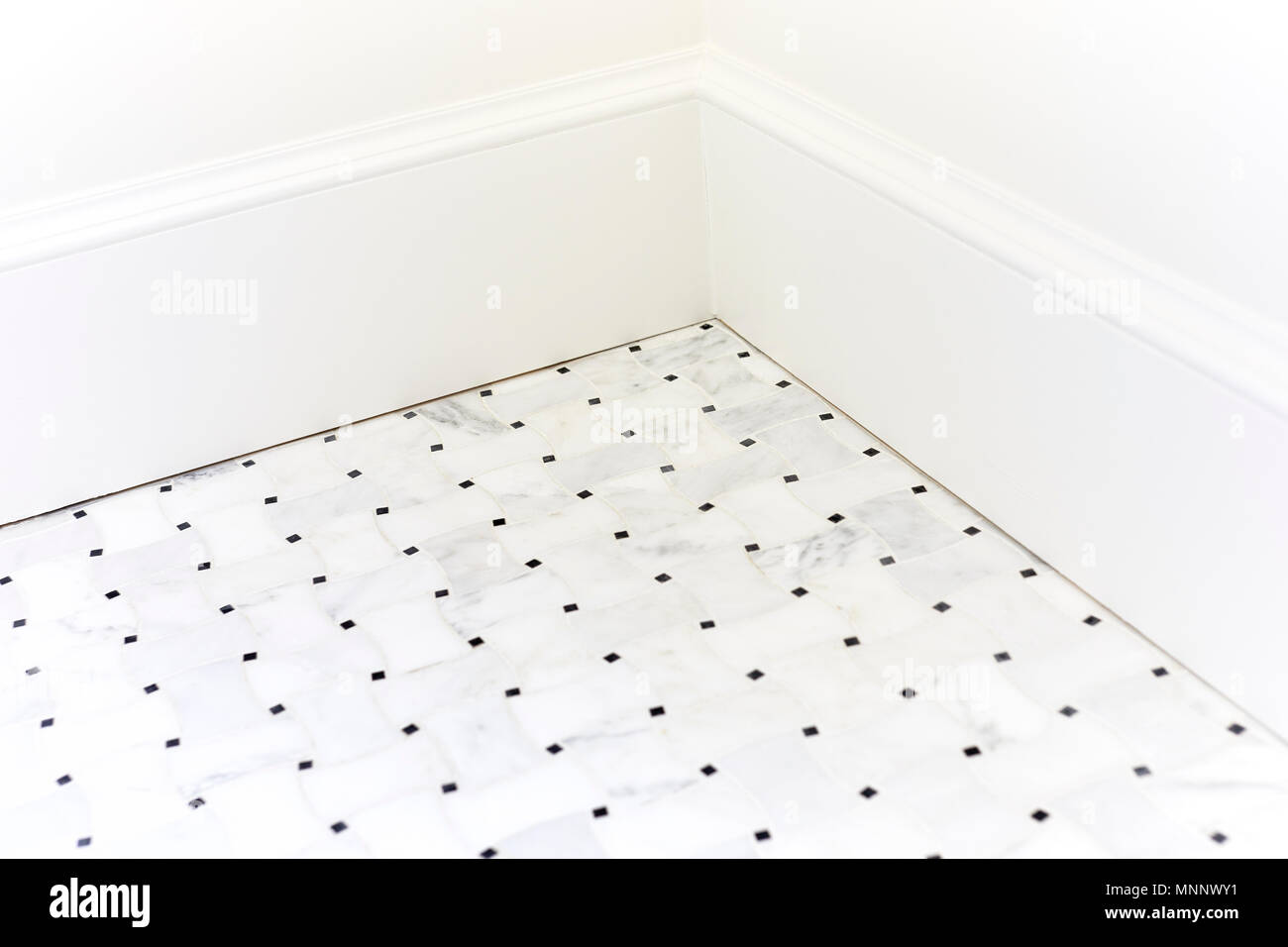 Marble tile floor in the corner with new baseboard moulding Stock Photo ...