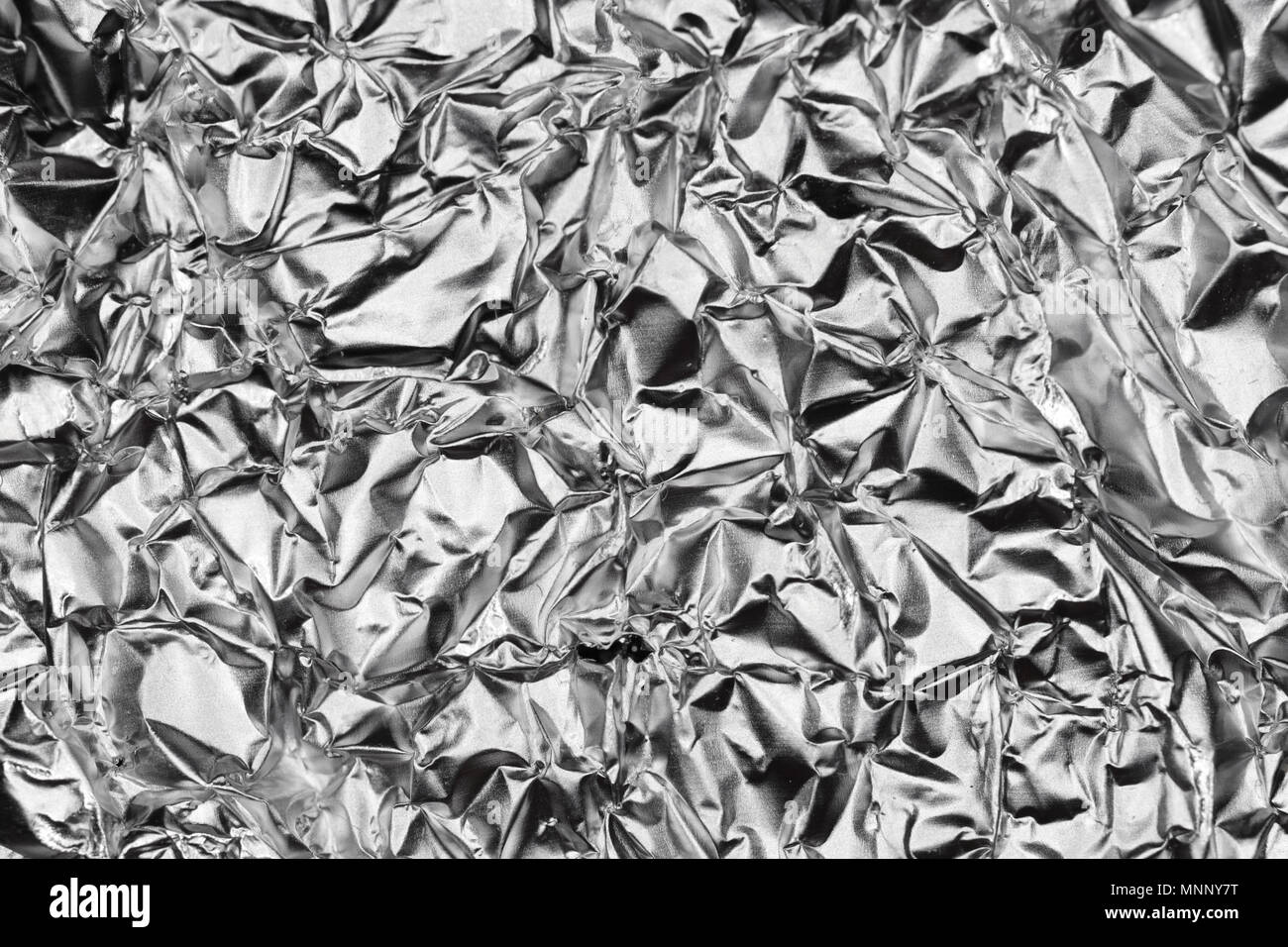 Silver Monochrome Crumpled Foil Texture. Metallic Black & White Background. Stock Photo