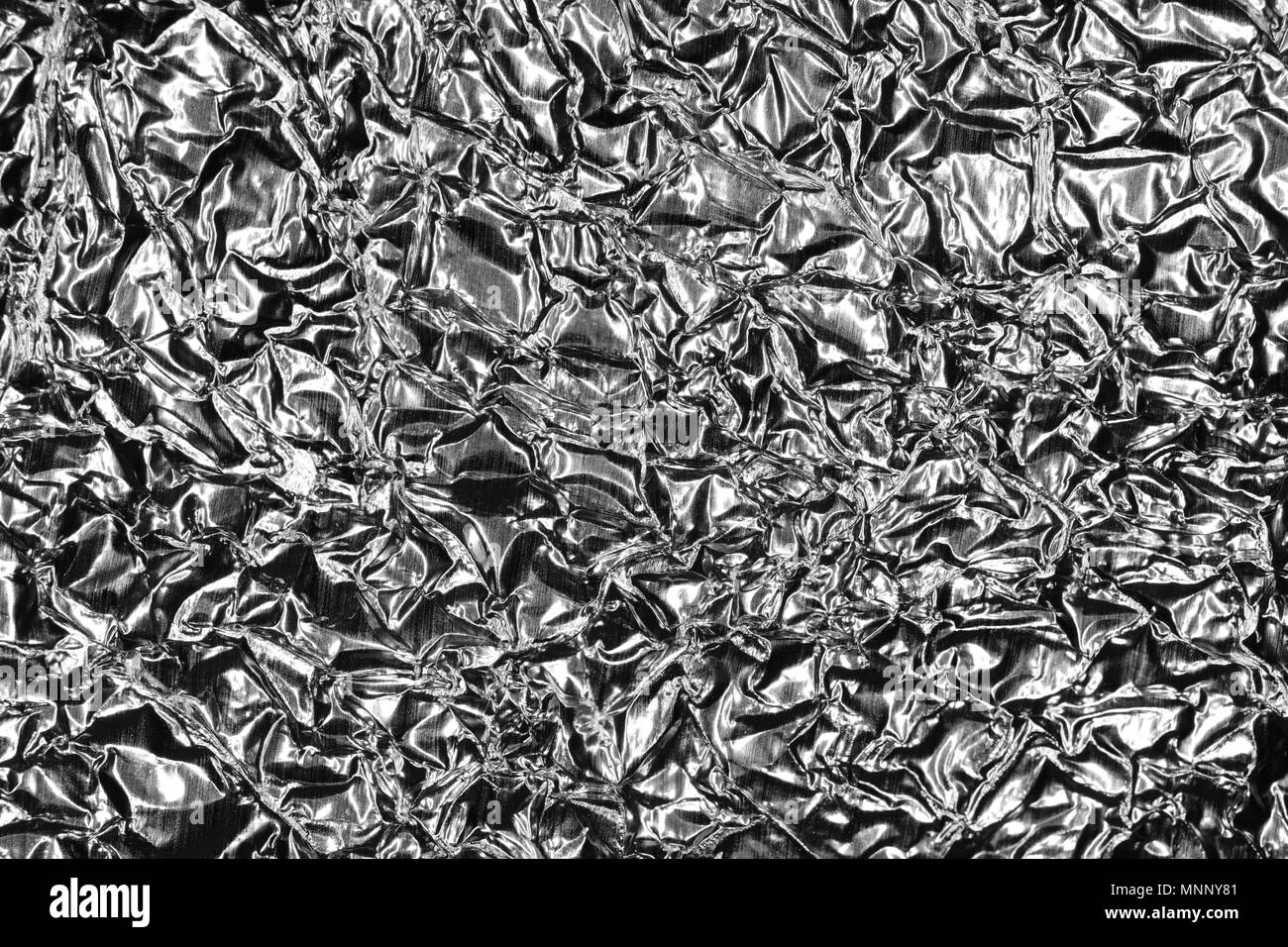 Monochrome Metallic Crumpled Foil Texture. Black & White Background. Stock Photo