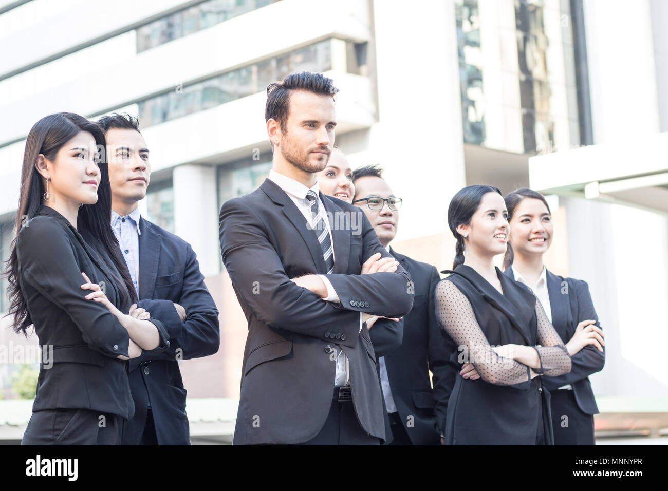 Teamwork and professional partnership concept, businesspeople team of multi ethnic standing  with confidence in full suit Stock Photo