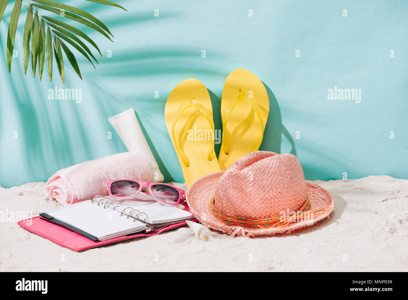 Summer accessories on sandy beach. Summer exotic relaxation concept. Copyspace for text Stock Photo
