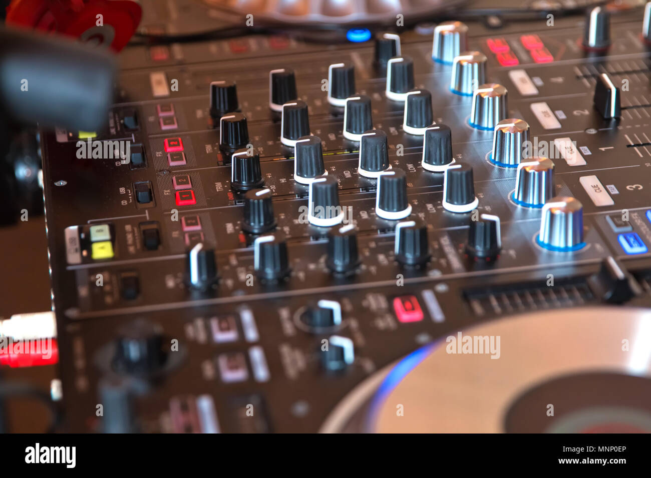 DJ booth at night club party for music mixing. DJ Spinning, Mixing, and