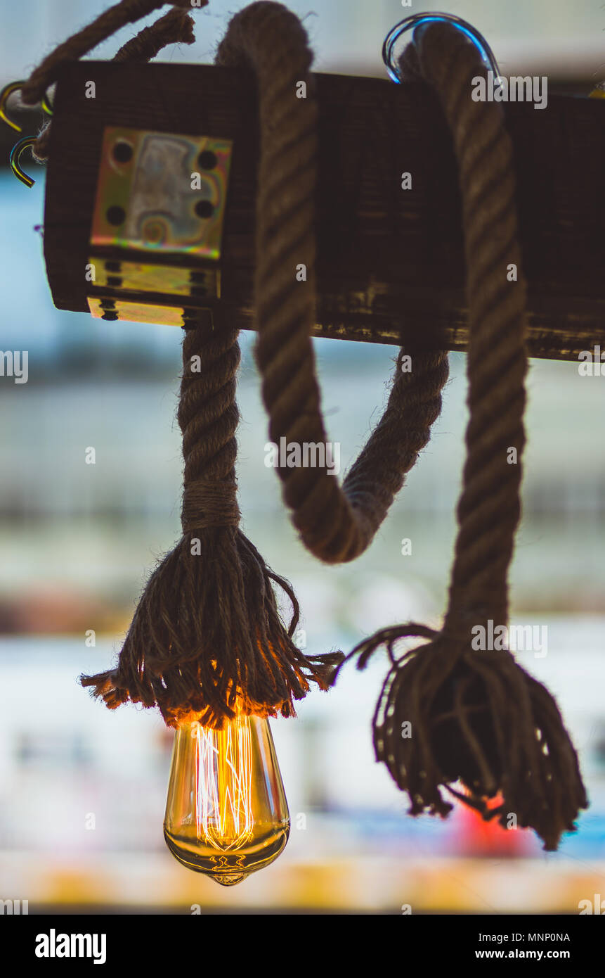 Rope light bulb with visible orange glowing filaments Stock Photo