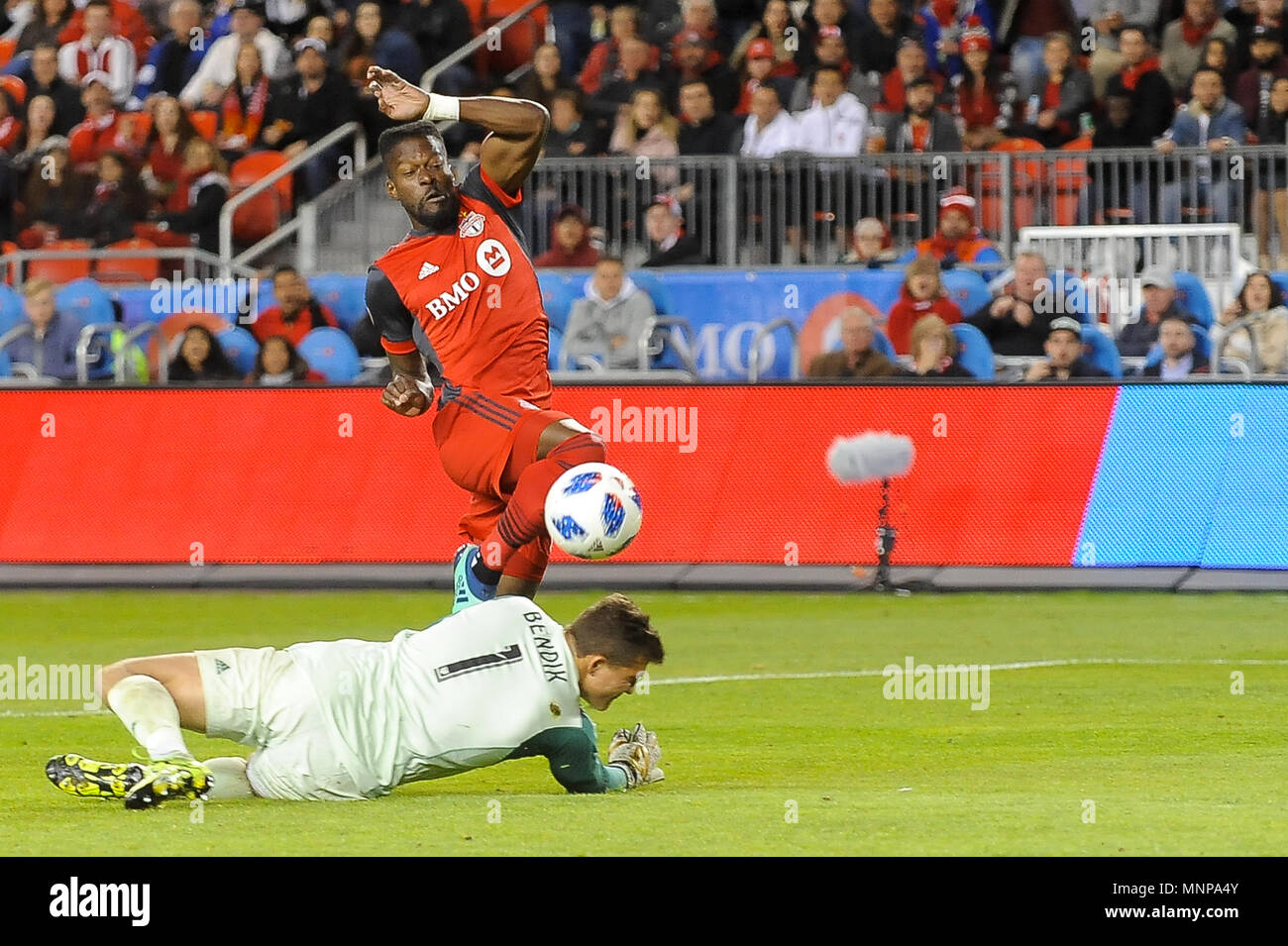 Tosaint Ricketts (87) punches the ball through the goalkeeper during 2018 MLS Regular Season match between Toronto FC (Canada) and  Orlando City SC (USA) at BMO Field (Score 2:1) Stock Photo