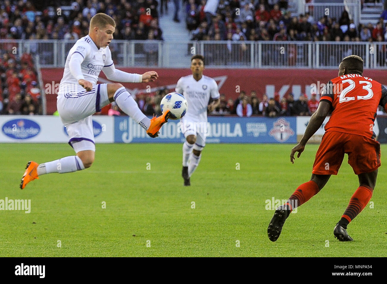 Chris Mueller (L) jumping for the ball during 2018 MLS Regular Season match between Toronto FC (Canada) and  Orlando City SC (USA) at BMO Field (Score 2:1) Stock Photo