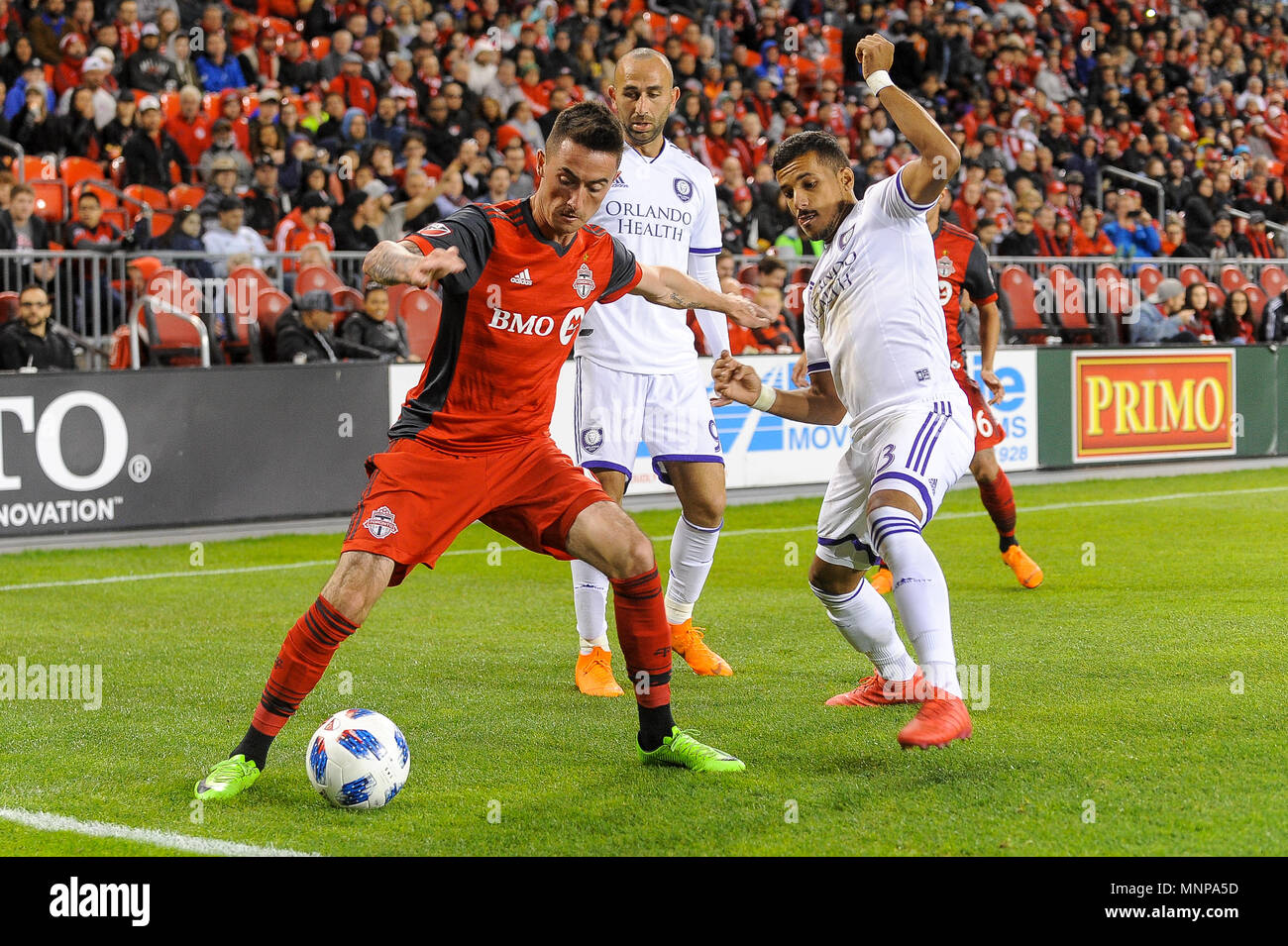 Jay Chapman (L) tried to get the ball during 2018 MLS Regular Season match between Toronto FC (Canada) and  Orlando City SC (USA) at BMO Field (Score 2:1) Stock Photo