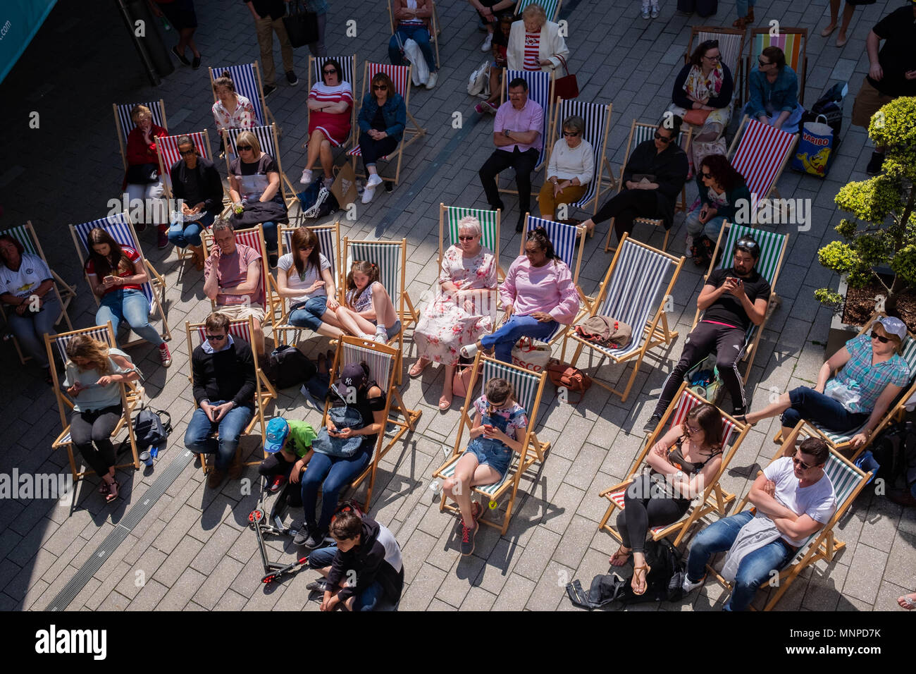 London, England, 19th May 2018.  A crowd is seated on deckchairs watching the Royal Wedding on a big screen at the LDO in Wembley Park © Tim Ring/Alamy Live News Stock Photo