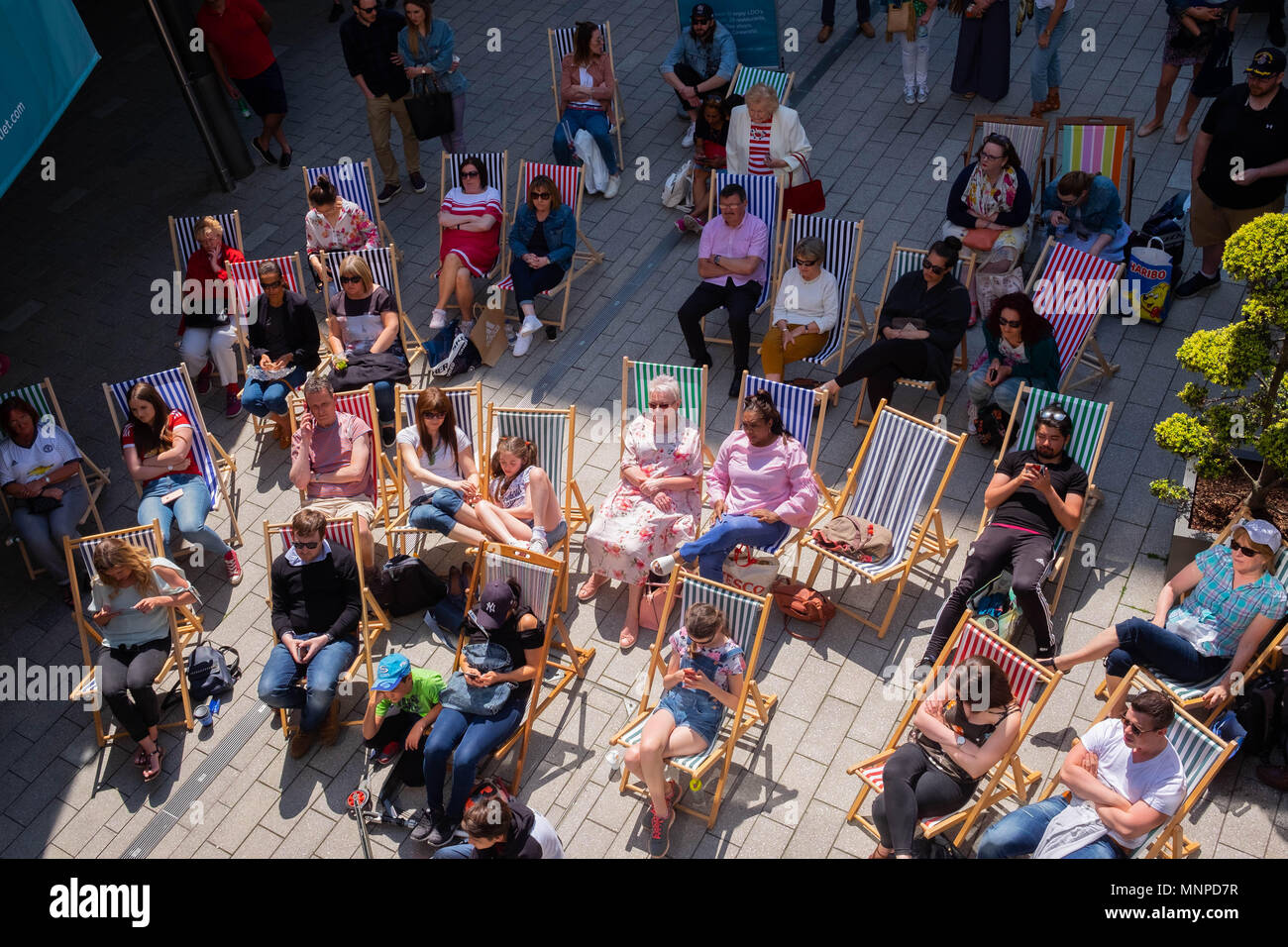 London, England, 19th May 2018.  A crowd is seated on deckchairs watching the Royal Wedding on a big screen at the LDO in Wembley Park © Tim Ring/Alamy Live News Stock Photo