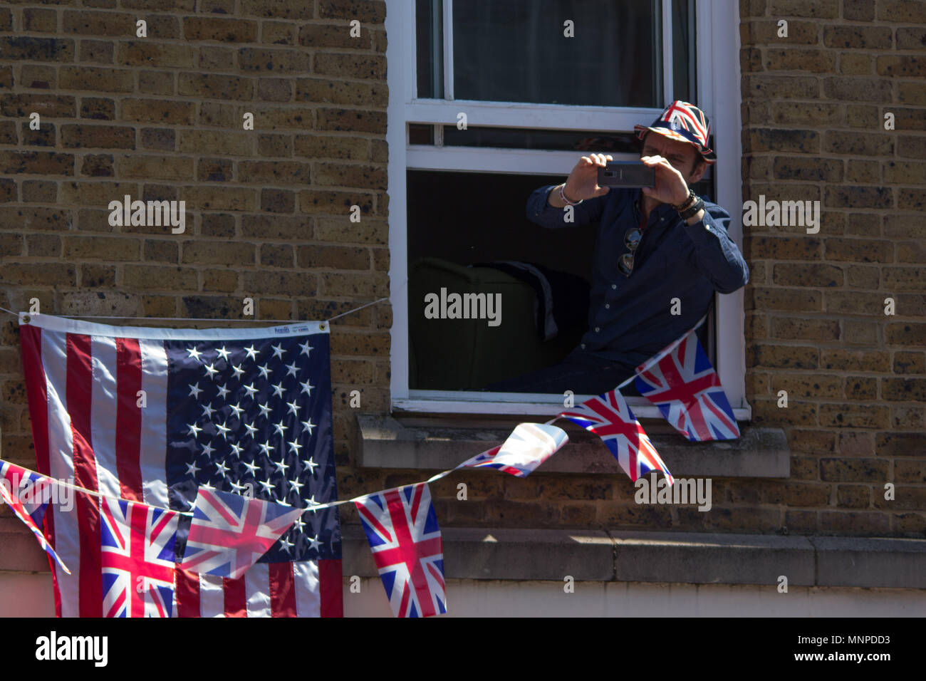 Windsor, Bershire, UK. 19th May, 2018. An onlooker prepares to snap a shot during the wedding procession of Prince Harry and Meghan Markle. Credit: Michael Candelori/ZUMA Wire/Alamy Live News Stock Photo