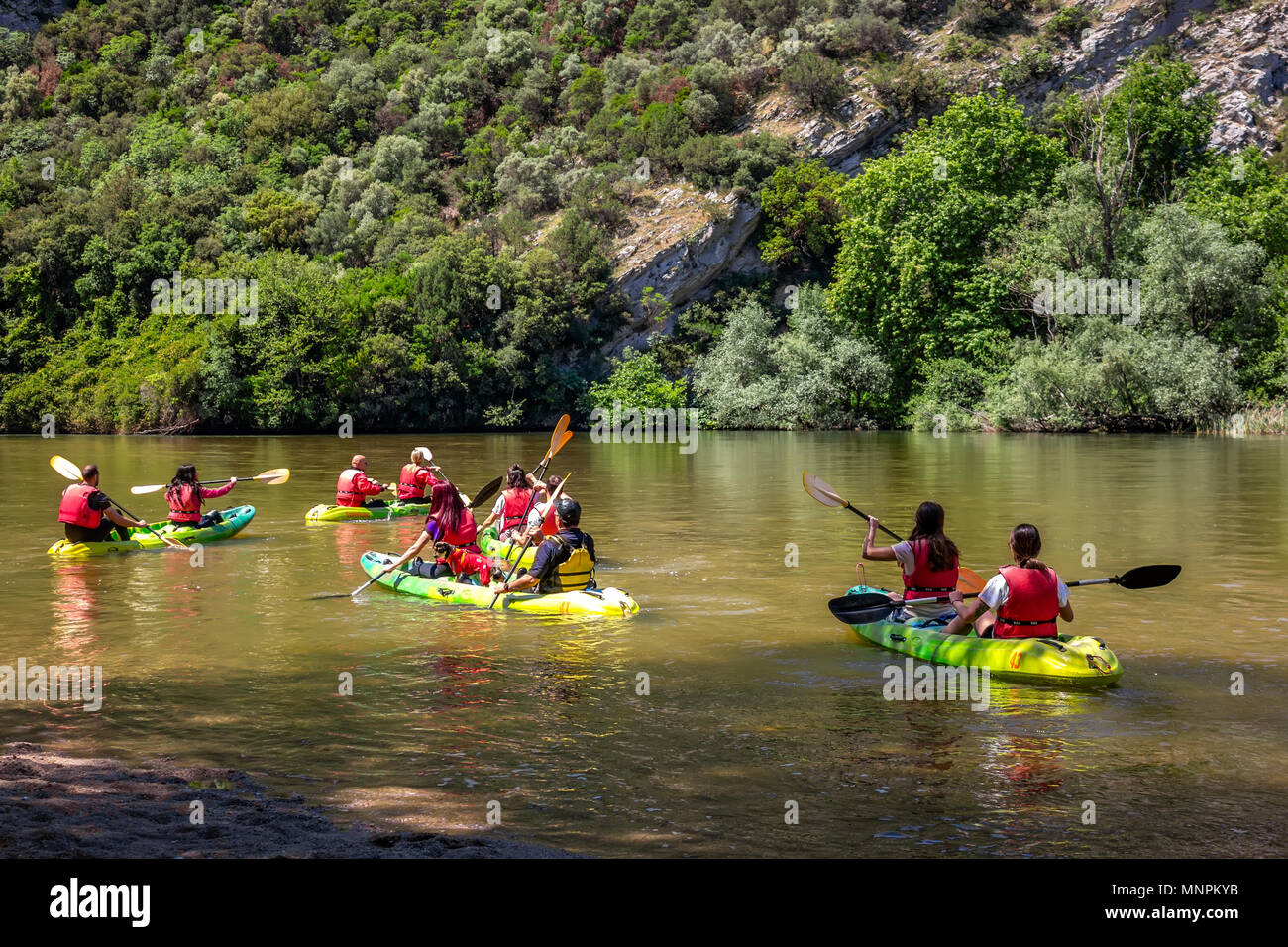 Canoe Kayak. Young people paddling hard the kayak near the cliff on river Nestos in Greece. Stock Photo