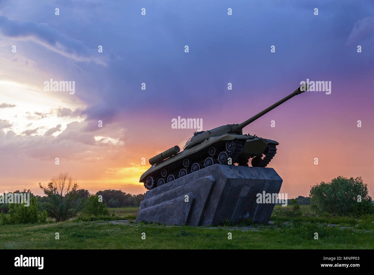 Soviet medium tank T-34-85 of the Second World War.Tank against the backdrop of the sunset and thunderstorm clouds Stock Photo
