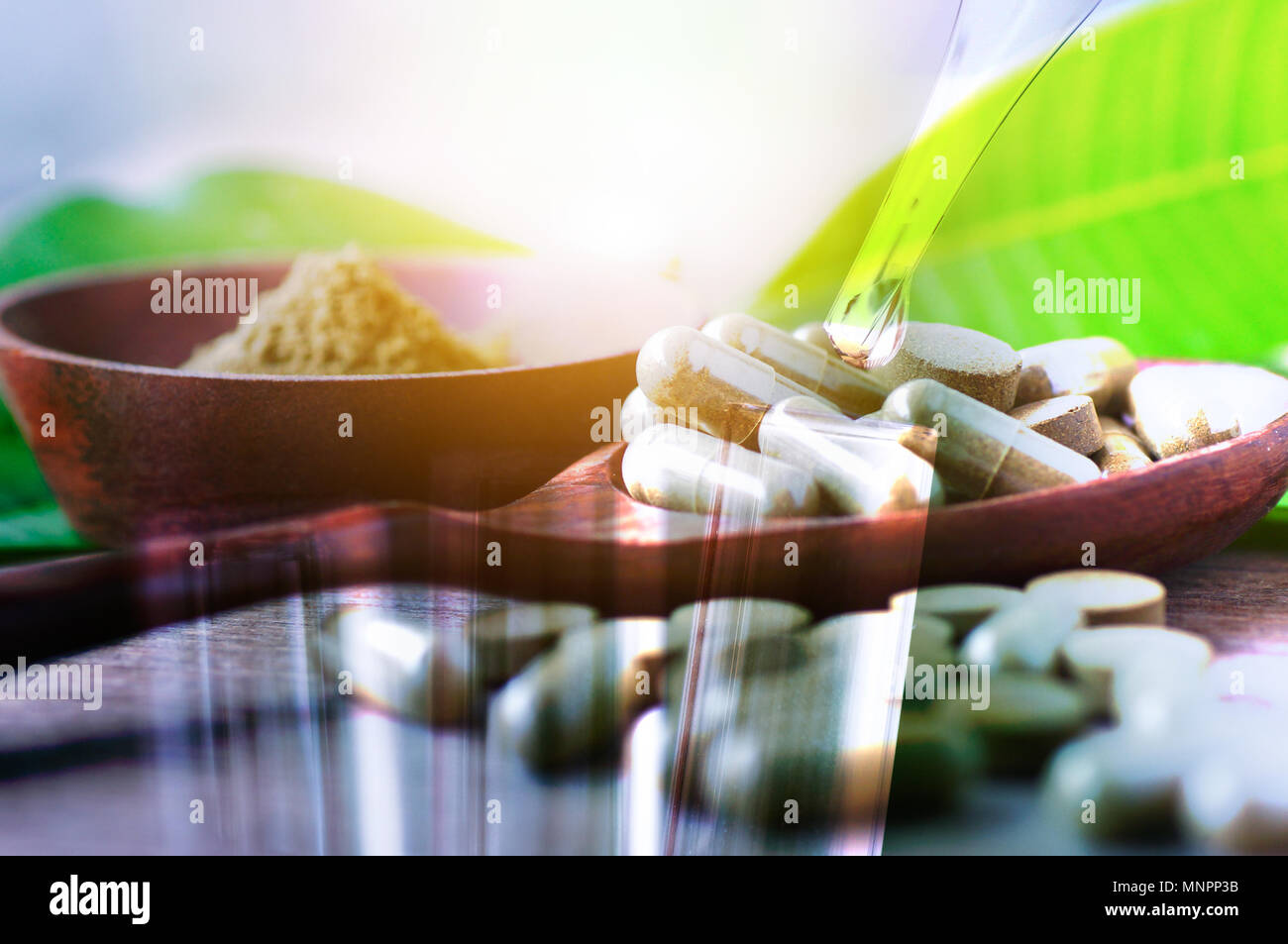 Double exposure test tube and herbal drug in pill and capsule on wood