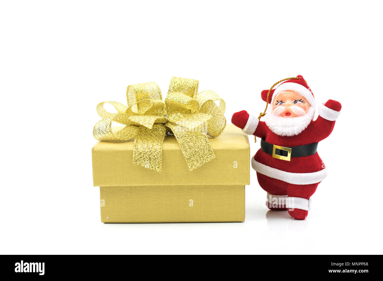 Santa claus doll and gift box isolated on white background Stock Photo ...