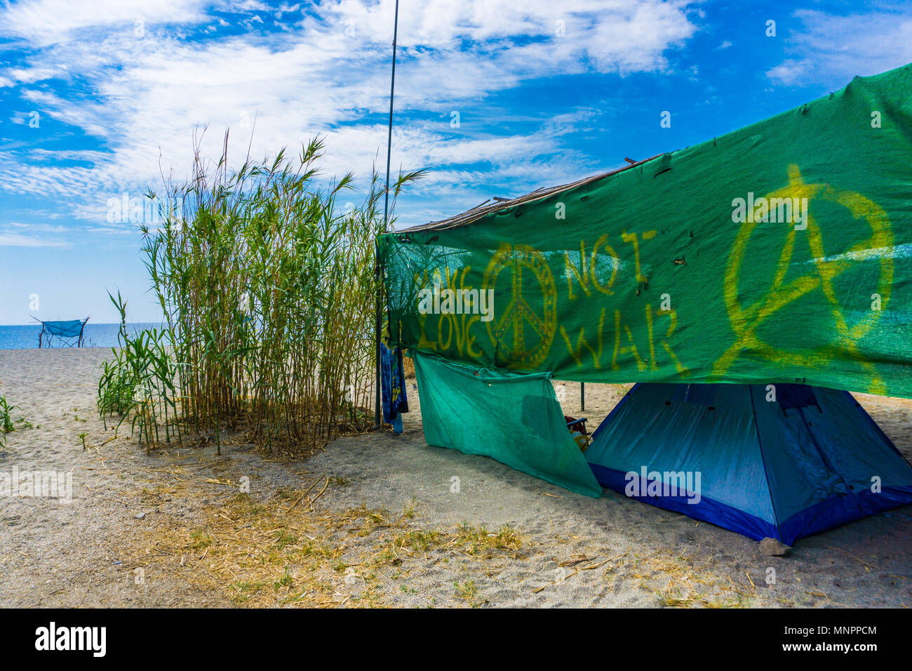 Camping at Vathi beach with blue crystal waters in eastern Mani region of  Peloponnese, Greece Stock Photo - Alamy