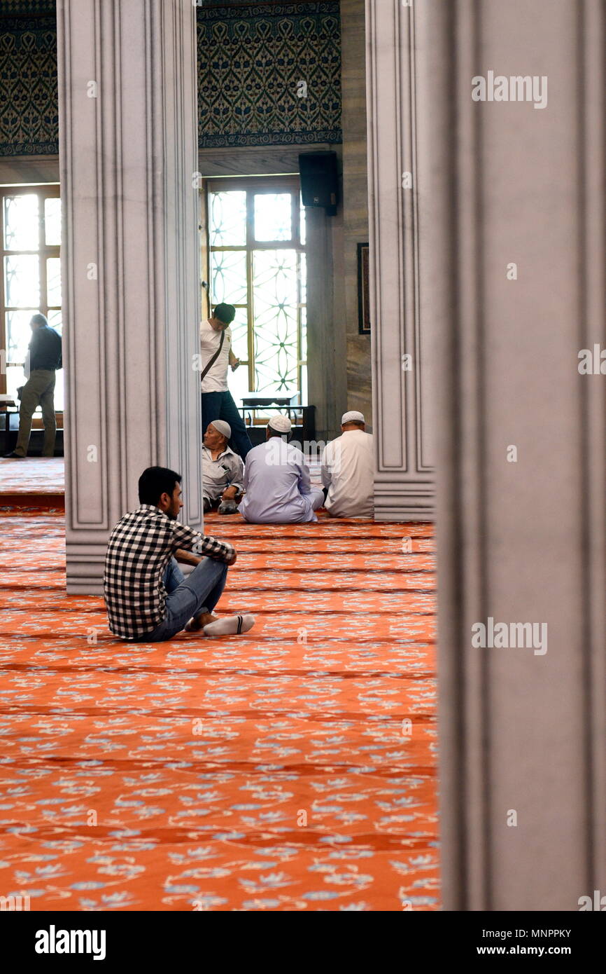 Istanbul, Turkey. Men pray in the Blue Mosque (Sultan Ahmed Mosque) at the noon prayer Stock Photo