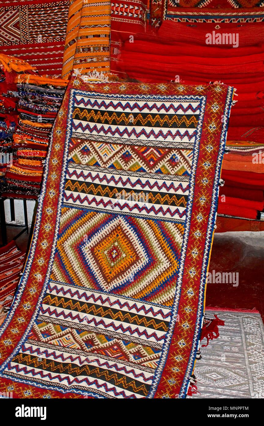 A display of colourful traditioal decorated carpet In the Souk the Street Market at Jemaa el Fnaa in the Medina Old City in the centre of Marrakech in Stock Photo