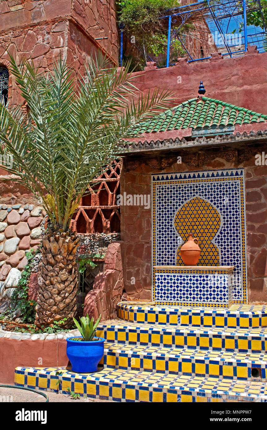 The decorated ceramic enterance to a studio pottery near Marrakech in Morocco with a palm tree Stock Photo