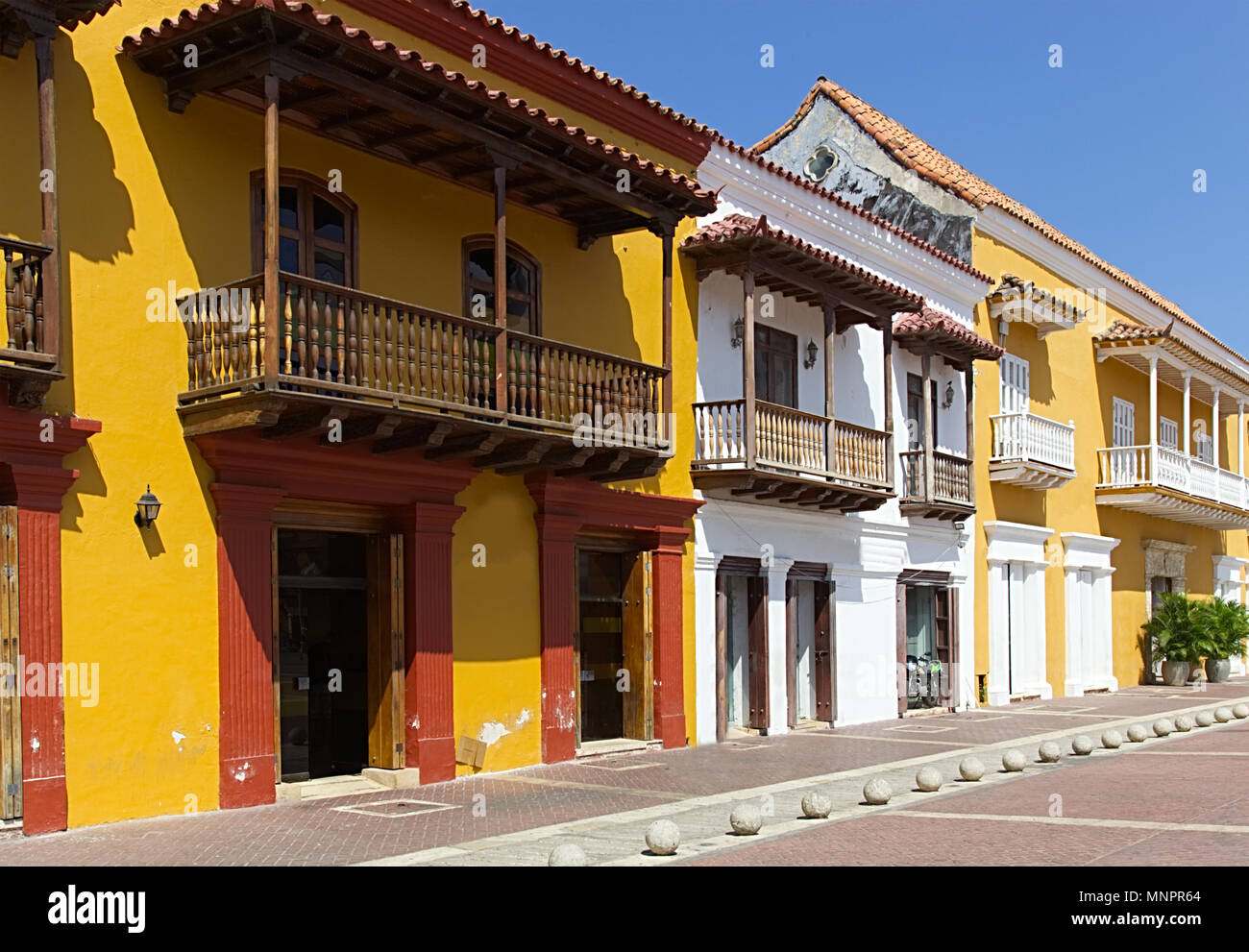 lovely yellow and orange homes and businesses in a spanish or caribbean
