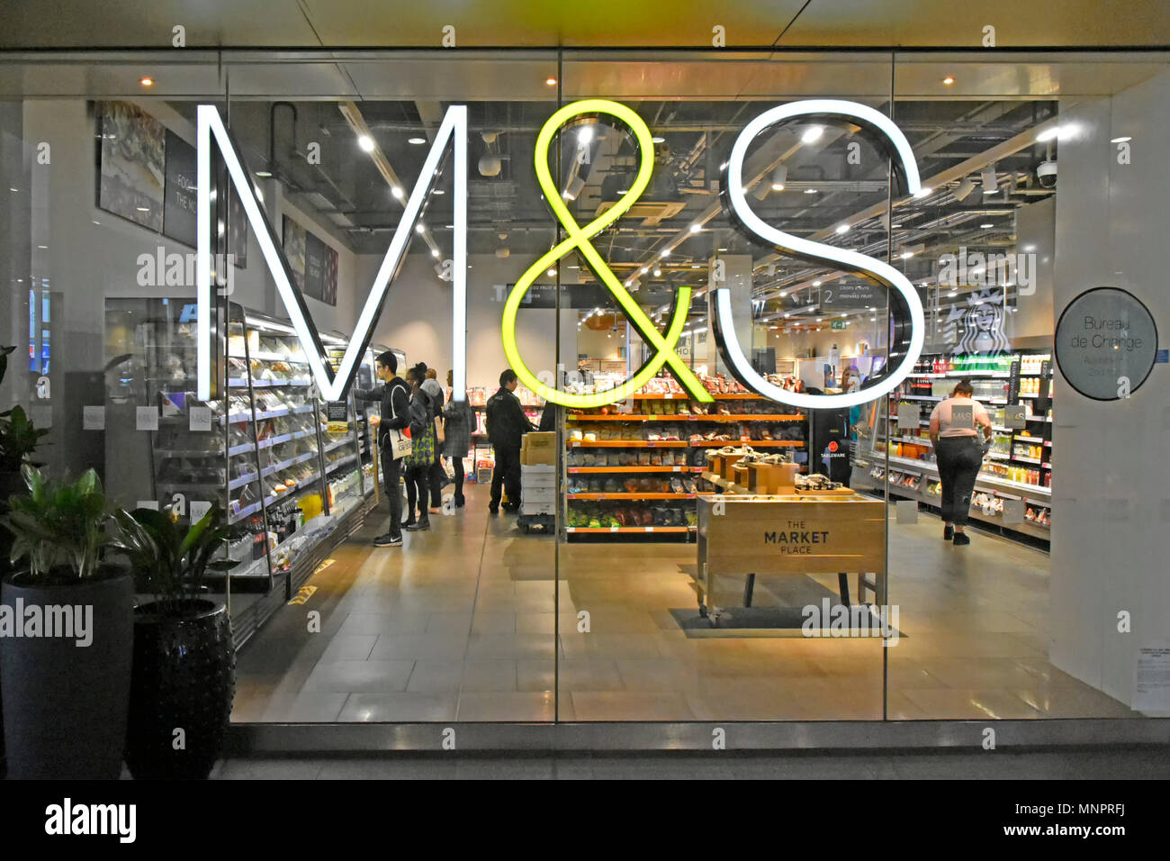 M & S M&S foodhall illuminated sign shop window & interior of Marks and Spencer food hall Westfield Shopping Centre Stratford East London England UK Stock Photo