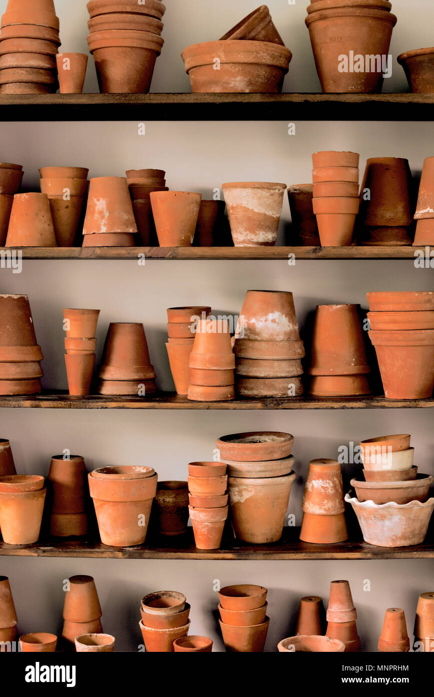 Shelves of stacked vintage clay pots Stock Photo