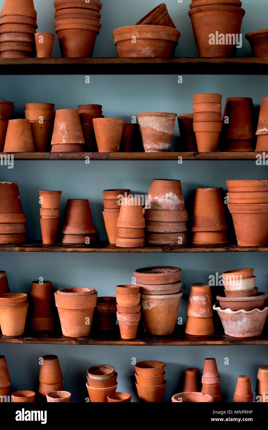 Shelves of stacked vintage clay pots Stock Photo