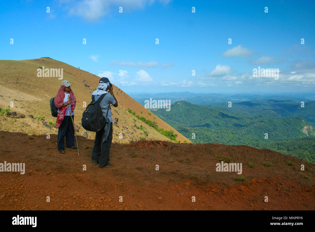 Trekkers enjoying the view from Kodachadri hill (Karnataka, India) Stock Photo