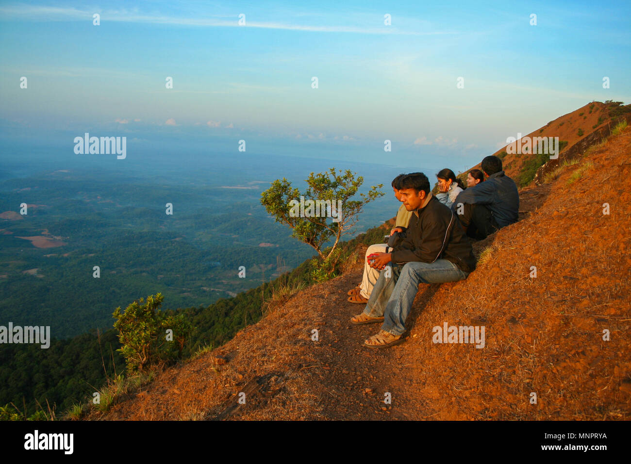 Trekkers enjoying the view from Kodachadri hill (Karnataka, India) Stock Photo