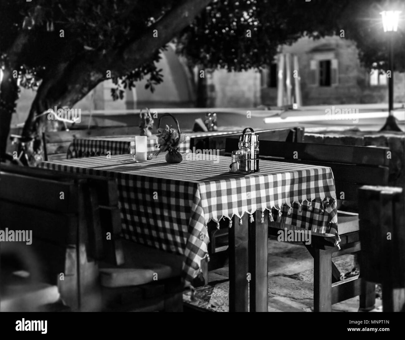 Monochrome, black and white image of empty dining tables. Stock Photo