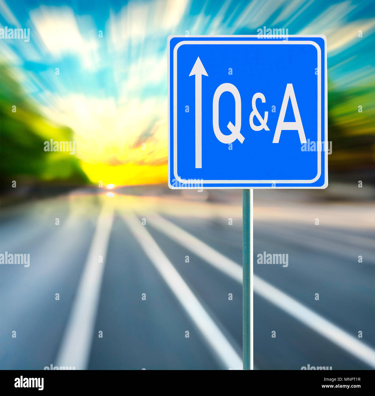 Q & A motivational phrase on blue road sign with arrow and blurred speedy background in sunset. Copy space. Stock Photo