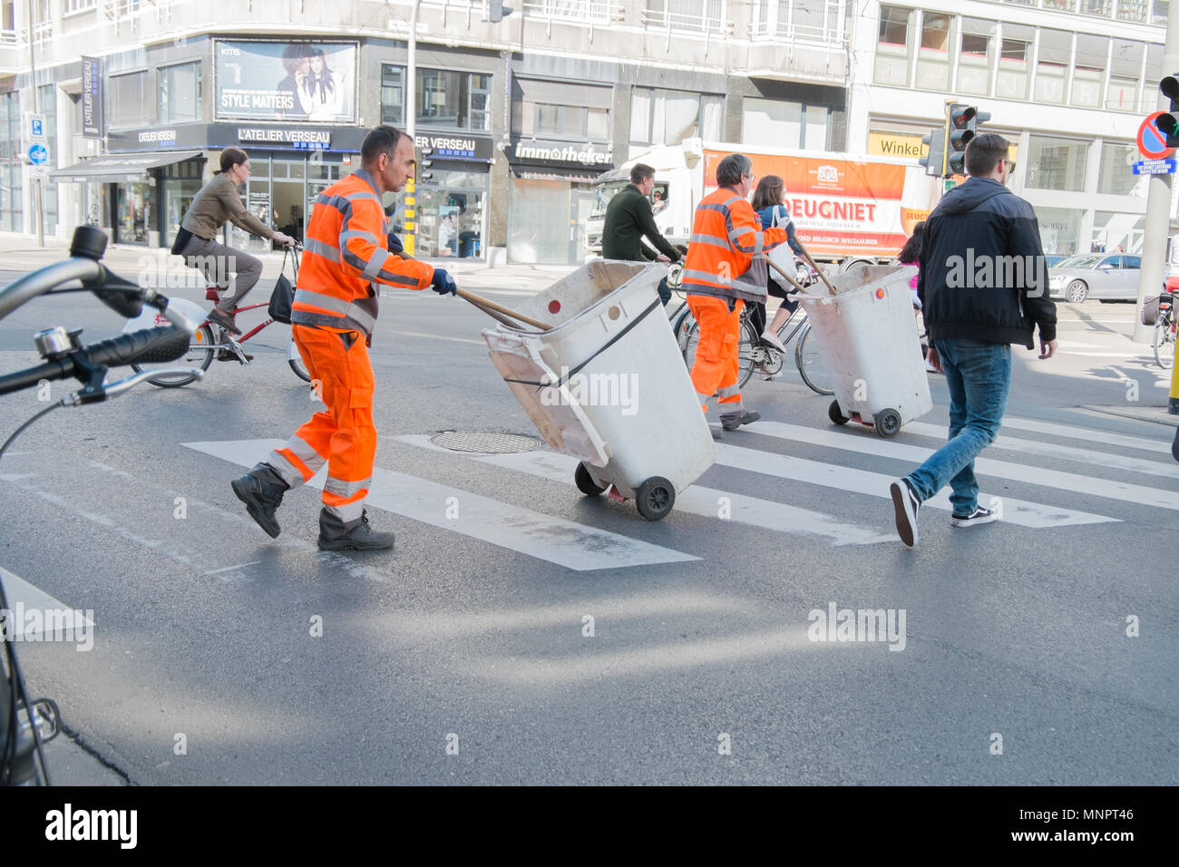 garbage collectors crossing street in antwerp, belgium Stock Photo Alamy