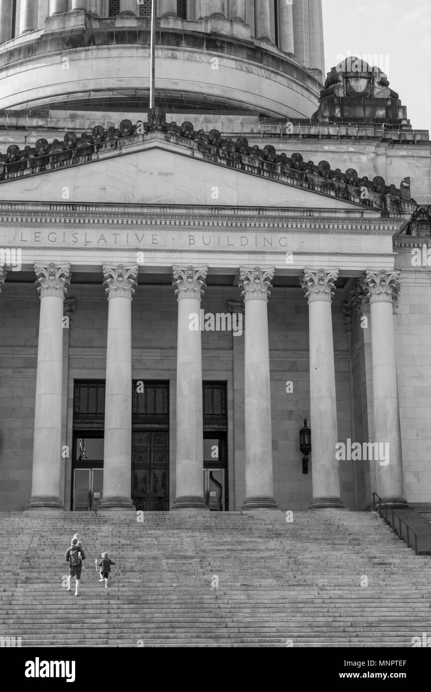 Olympia, Washington / USA - May 5, 2018: A father and his children walk up the steps of the Washington State Capitol building carrying balloons on a b Stock Photo