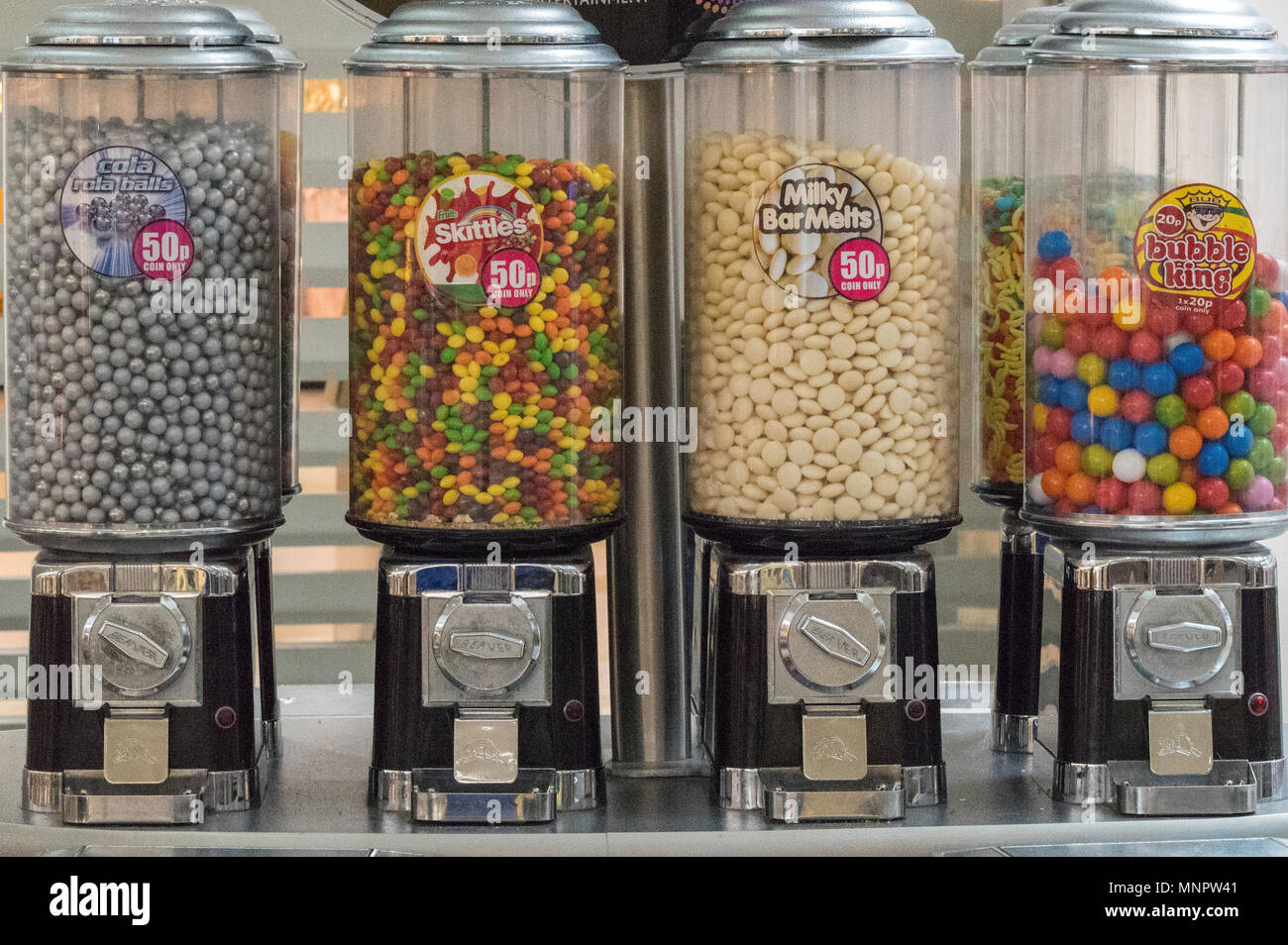 Sweets and bubble gum machines or dispensers coin operated in shopping